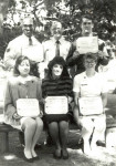 Martha McCaslin (bottom row,
furthest to the right) shows a military
award she received for outstanding
performance during an occupational
safety inspection while she was
stationed in Greece.