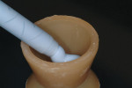 Figure 16  Fill a small vessel with bite registration material. (<strong>17</strong>.) Next, apply a layer of bite registration material to the abutment and analog to ensure a complete impression is taken.