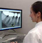 Figure 1 Dr. Lee annotates a digital radiograph on a 24-inch LCD display, with a native resolution of 1,920 by 1,200 pixels (WUXGA). Monitor size, brightness, contrast, and resolution are important components of a well-configured digital radiography syste