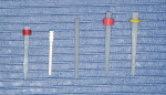 Figure 1  Examples of fiber posts. Note the differences in shape, opacity, and translucency. Posts left to right: Twin Luscent Anchors, Peerless Post, UniCore, RelyX Fiber Post, D.T. Light Post.