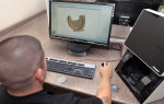 Fig 1. A technician at Oral Designs Dental
Laboratory works on a case using scanning software for scanning impressions.