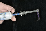 Figure 4  The syringe is attached to the handgun dispenser.